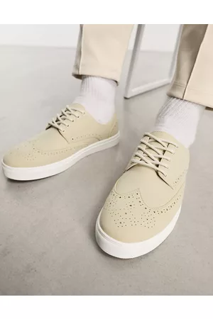 ASOS DESIGN lace-up sneakers in white with embossed monogram