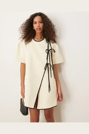 Ghospell Asymmetric contrast bow mini dress in pearl ivory