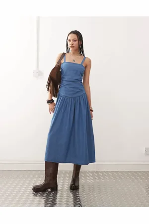 Reclaimed Dropped waist gathered detail midi denim dress in authentic midwash
