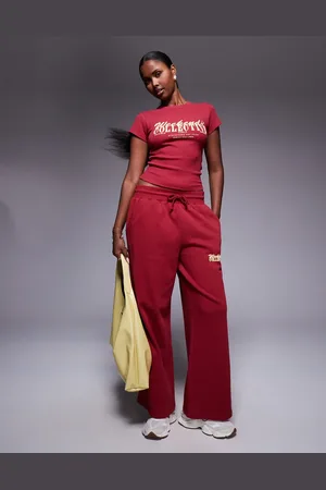 ASOS Weekend Collective wide leg sweatpants with mixed font graphic in burgundy