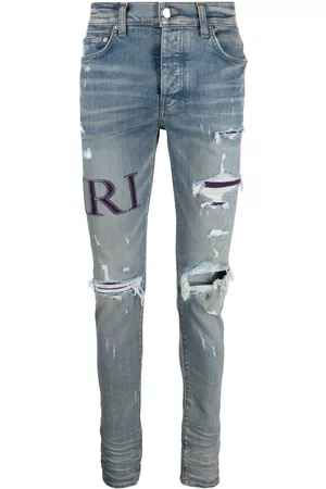 AMIRI Men Skinny Jeans - Ripped-knee logo-print skinny jeans - Blue